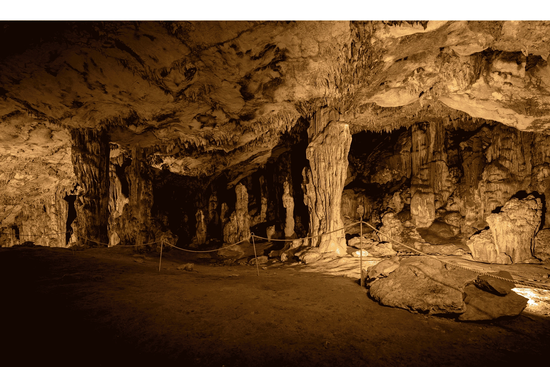 Interior of Grapčeva Cave on Hvar Island, showing dramatic stalactites, stalagmites, and illuminated limestone formations.